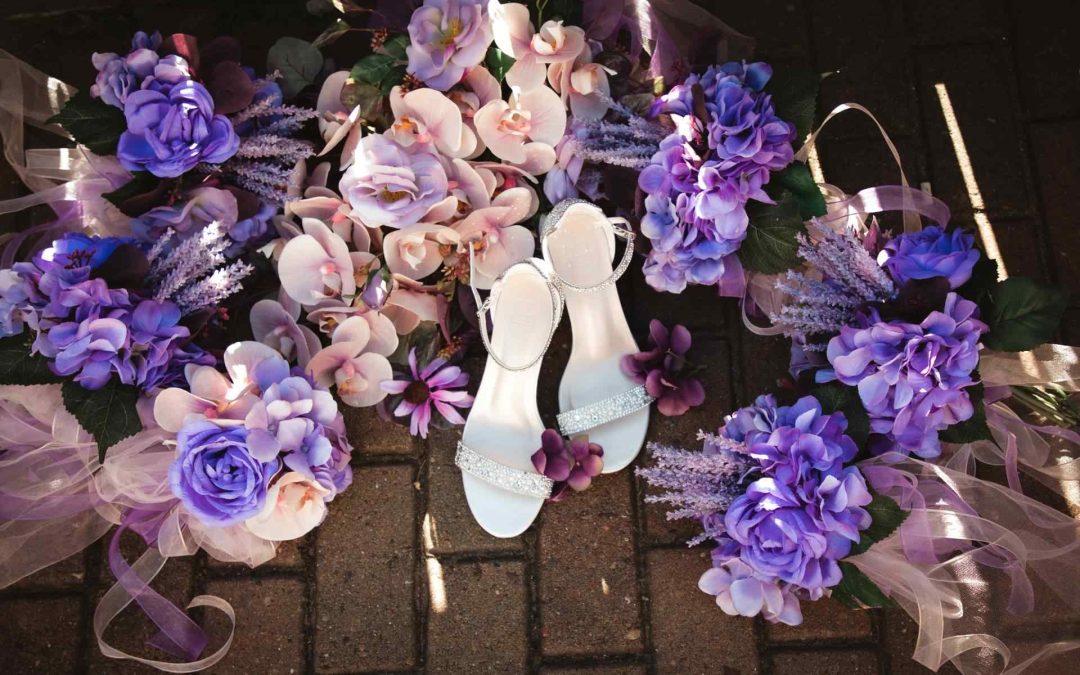 silver heels surrounded by pink and purple flowers
